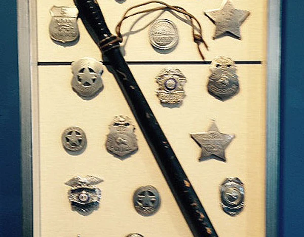 Police shields with an antique billy club